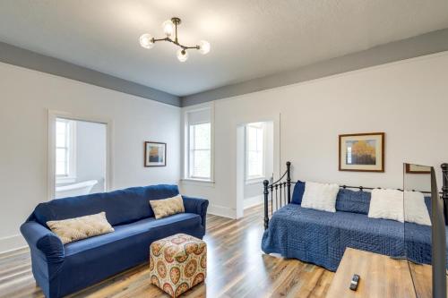 a living room with a blue couch and a bed at Modern Augusta Vacation Rental about 1 Mi to Colleges! in Augusta