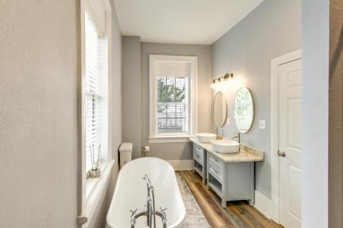 a bathroom with a tub and a sink and mirror at Modern Augusta Vacation Rental about 1 Mi to Colleges! in Augusta