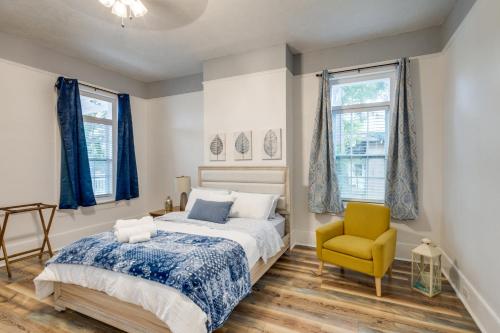 a bedroom with a bed and a yellow chair at Renovated Augusta Apartment about 1 Mi to Downtown! in Augusta