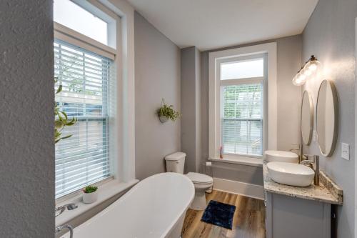 a bathroom with a tub and a toilet and two mirrors at Renovated Augusta Apartment about 1 Mi to Downtown! in Augusta