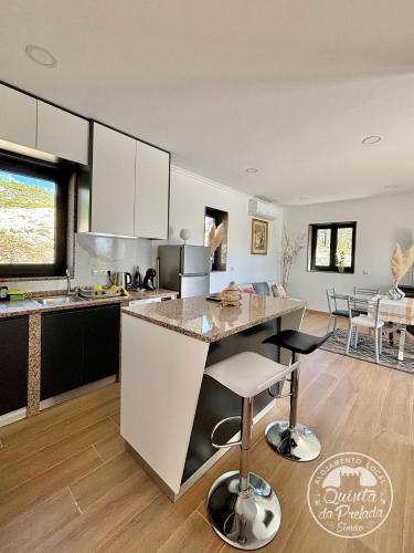 a kitchen with a large island in a room at Casa 2 do Pavilhão da Prelada in Celorico de Basto