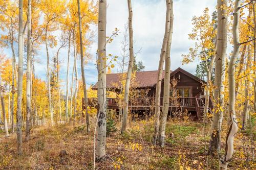 a log cabin in the woods with trees at Aspen Lookout by Great Western Lodging in Breckenridge