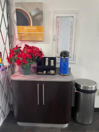 a small counter with flowers on top of it at Travelodge by Wyndham Vernon CT in Vernon