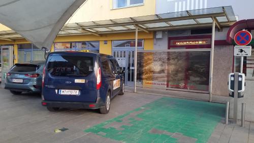 a small car parked in front of a store at Zimmervermietung Müller in Zeltweg
