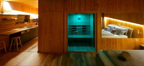 a kitchen with a glass door with a couch in it at Mámor Kuckó in Kistolmács