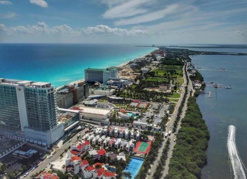 an aerial view of a resort next to the ocean at Amazing Villas at Las Cupulas in Cancún