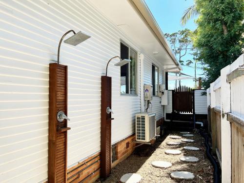 a house with two lights on the side of it at Vila Paus Satu - Ocean Views Hervey Bay in Hervey Bay