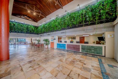 a large lobby with plants on the walls at Beach Park Resort - Suites in Aquiraz