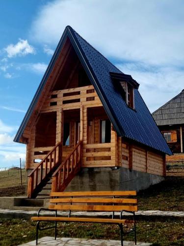 a log cabin with a bench in front of it at ETNO SELO VEZIROV RANČ in Sjenica