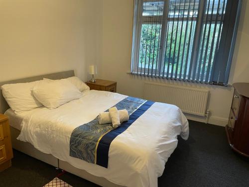 ein Bett mit zwei Kissen darauf in einem Schlafzimmer in der Unterkunft 4 Bed: 5mins frm Wembley Stadium in London