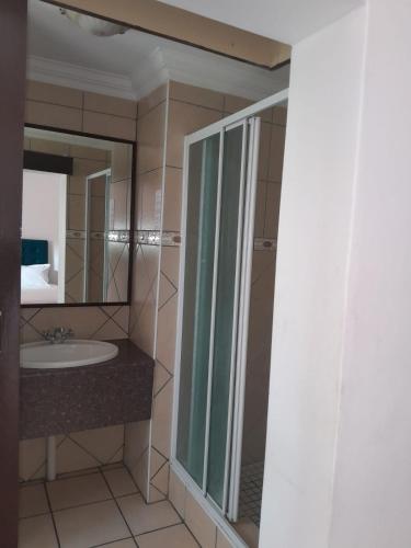 a bathroom with a sink and a mirror at Sapphire Hotel Halevy Heritage in Bloemfontein
