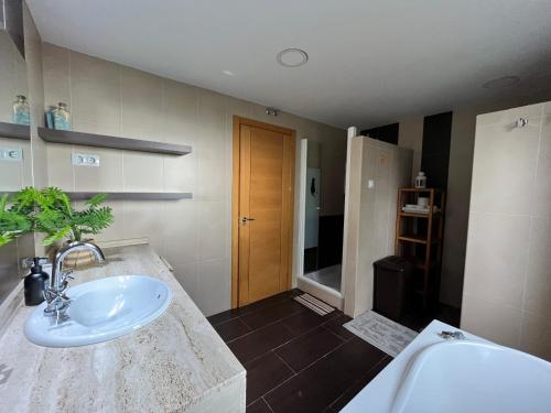 a bathroom with a sink and a counter top at El Sitio de Pepe in Valdeaveruelo