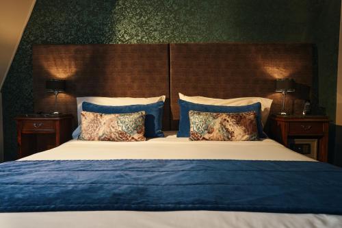 a bedroom with a bed with blue sheets and pillows at Miravida Soho Hotel & Wine Bar in Buenos Aires