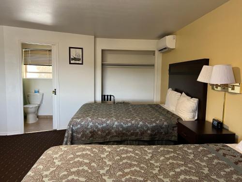 a hotel room with two beds and a bathroom at Port Townsend Inn in Port Townsend