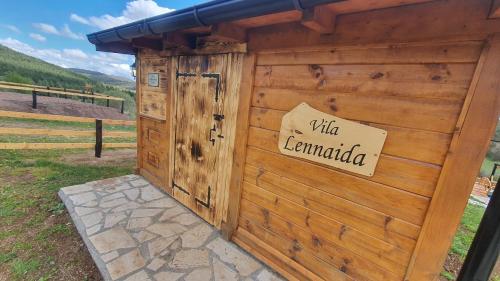 a wooden out house with a sign on it at ETNO SELO VEZIROV RANČ in Sjenica