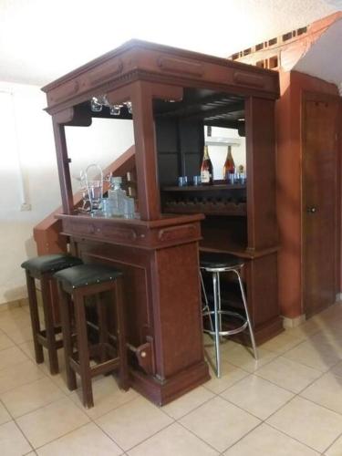 a wooden bar with stools in a room at GR20acd Jany in Cuauhtémoc
