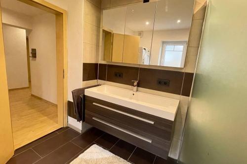 a bathroom with a sink and a mirror at Shine Apartment Schwarzenfeld in Schwarzenfeld