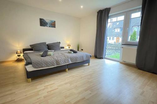 a bedroom with a bed and a large window at Shine Apartment Schwarzenfeld in Schwarzenfeld