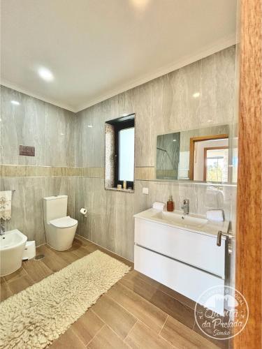 a bathroom with a white sink and a toilet at Casa 2 do Pavilhão da Prelada in Celorico de Basto
