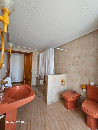 a bathroom with a red sink and a toilet at Hotel Blue Spot in Malgrat de Mar