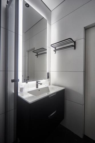 a bathroom with a sink and a mirror at Apart Hotel Acropolis in Odesa