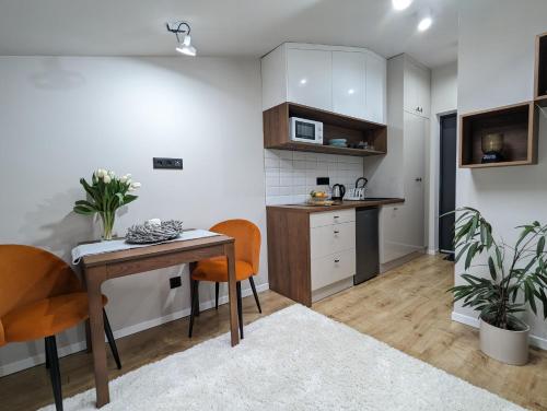 a kitchen with a table and chairs in a room at Kolejowy Zajazd 2 in Łódź