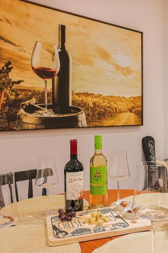 a table with wine bottles and glasses on it at Pousada e Adega Lapa do Lobo in Conservatória