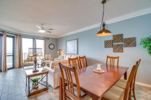a dining room and living room with a table and chairs at Beachfront Orange Beach Condo with Ocean Views! in Orange Beach