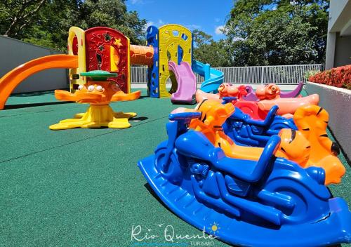 a group of childrens play equipment on a playground at Hotel Park Veredas in Rio Quente