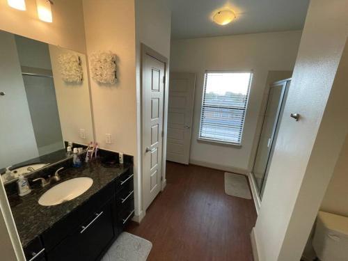 a bathroom with a sink and a toilet and a mirror at BEAUTIFUL STUDIO 7MIN FROM THE GALLERIA MALL in Houston