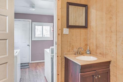 a bathroom with a sink and a mirror at Spacious West Virginia Home Ride to ATV Trails! 