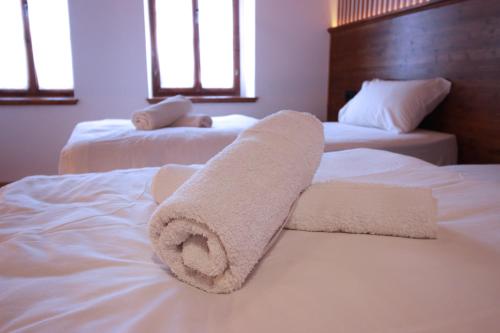 a towel is laying on top of two beds at Grey Stone in Gjirokastër