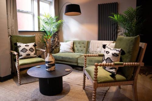 a living room with a couch and two chairs and a table at Turkish Baths Retreat, City Centre in Sheffield
