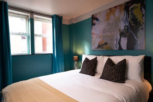 a bedroom with a large white bed with two pillows at Turkish Baths Retreat, City Centre in Sheffield
