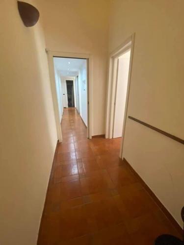 an empty hallway with a tile floor and white walls at Sole Urbano in Messina
