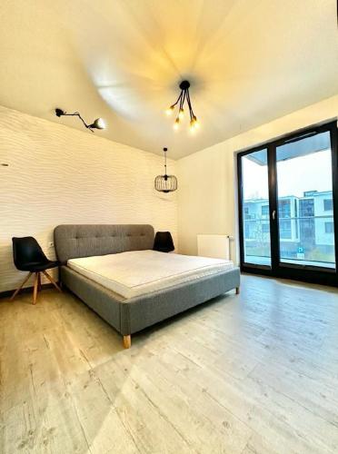 מיטה או מיטות בחדר ב-Apartament Bernadowska 11
