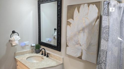 a bathroom with a sink and a mirror at Princesa de Penasco B208 - Family Beach Getaway in Puerto Peñasco