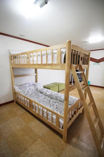 a couple of bunk beds in a room at The Red House in Sokcho