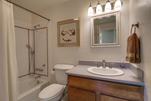 a bathroom with a sink and a toilet and a tub at West Hills HideAway in Bend