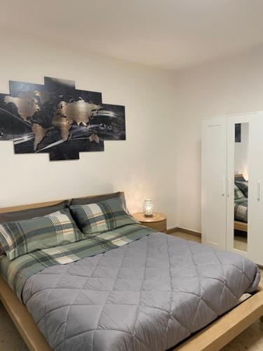 a bedroom with a bed with a gray comforter at B&B IL QUADRIFOGLIO in Iesi