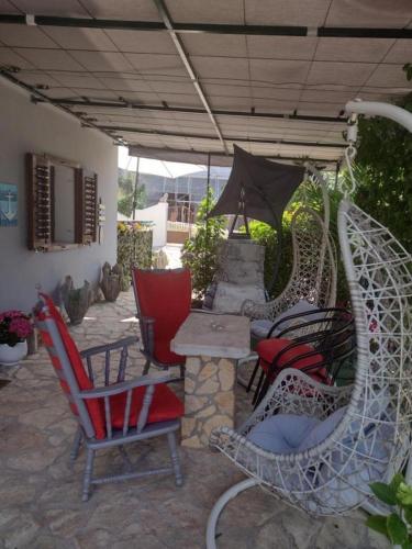 a patio with chairs and a table and an umbrella at Apartment AMare in Šibenik