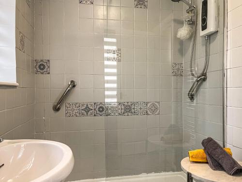 a bathroom with a shower and a sink at Harris House in Staveley