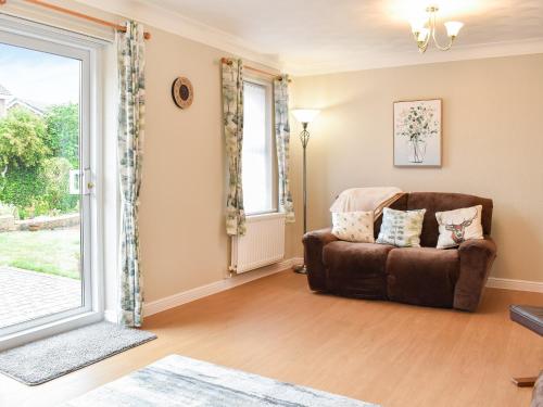 a living room with a couch and a window at Meadowfield View in Ryton