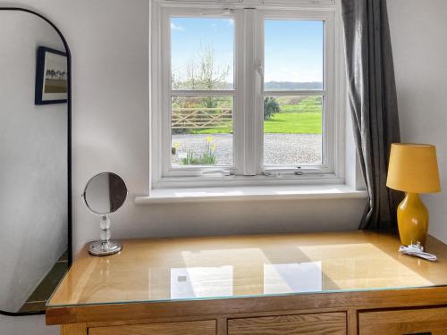 a dressing table with a mirror and a window at Waveney Valley View in Burgh Saint Peter