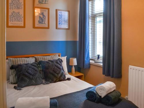 a bedroom with a bed with two towels on it at Hogarth Apartment By The Sea in Newbiggin-by-the-Sea