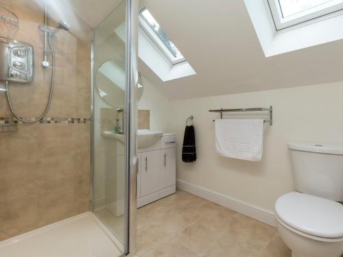 a bathroom with a shower and a toilet and a sink at The Lodge in Skipwith