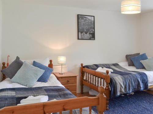 a bedroom with two twin beds and a night stand at Sunnyside in Delabole