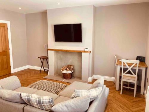 a living room with a couch and a fireplace at Central Skipton - Devonshire Court Apartment 2 in Skipton