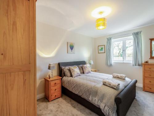 a bedroom with a bed and a window at Barn Cottage in Falfield