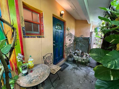 a room with a blue door and a table and chairs at Miami Bungalow Oasis near Everglades & The Keys in Cutler Bay